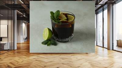 Glass of Cuba Libre on white textured table Wall mural