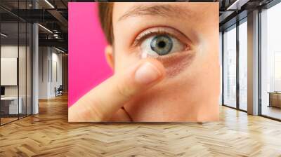 Installation of a contact lens in the eye close-up Wall mural