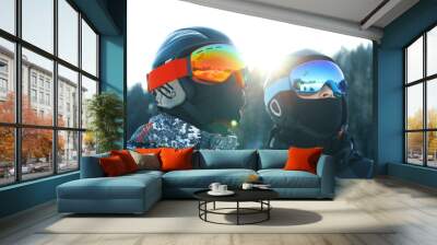 Male skiers in ski helmets and goggles in mountain resort Wall mural