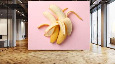 Opened bananas on pink background. Fresh fruit Wall mural