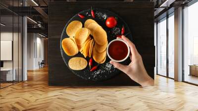 Potato chips in a bowl with chili pepper and sauce Wall mural