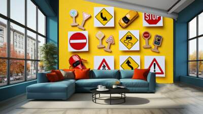 Road signs and vehicles on a yellow background. Wall mural