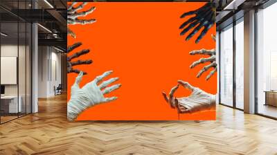 Scary hands of monsters on an orange background, created with Generative AI technology. Wall mural