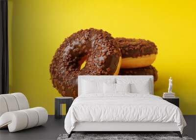 Tasty donuts on yellow background, close up Wall mural