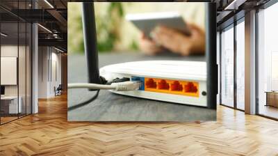 Wi - fi router on gray wooden table, close up Wall mural