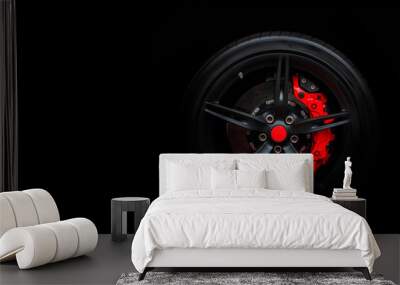 Isolated generic sport car wheel with red breaks drifting and smoking on a black background Wall mural