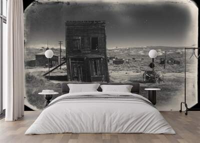 Very old sepia vintage photo with abandoned and crooked western city building built during gold rush, Bodie Wall mural