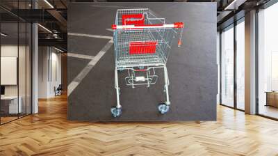 metal trolley shopping basket at asphalt background Wall mural