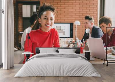 Black business woman in casual red top at office meeting Wall mural