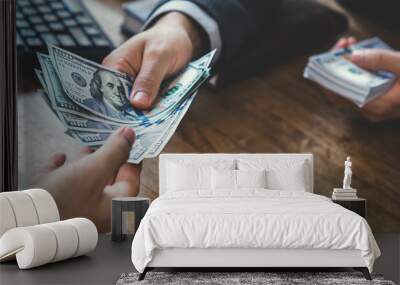 Businessman giving money to a man at working desk Wall mural