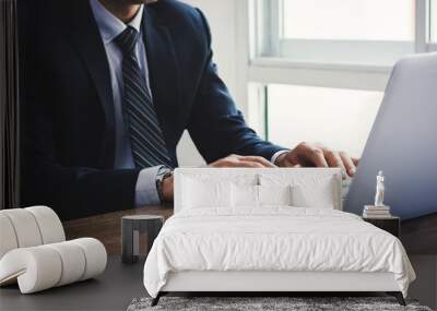 Businessman working on notebook computer in the office Wall mural