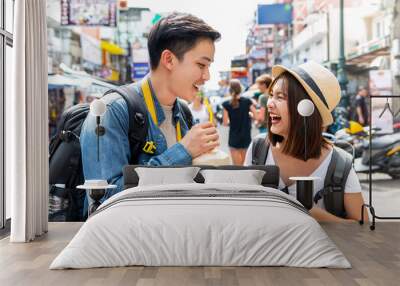 Happy Asian couple tourist backpackers traveling in Khao San road ,Bangkok Wall mural