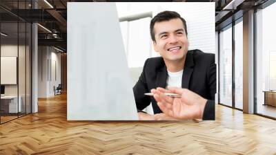 Happy businessman discussing work with his colleagues at the meeting in the office Wall mural