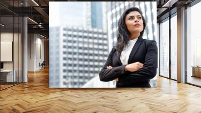 Powerful Latin businesswoman leader standing with arm crossed Wall mural