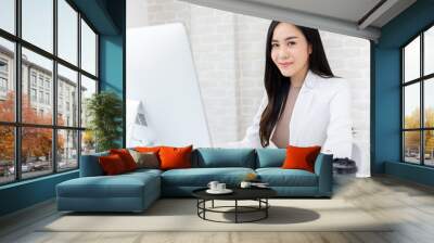 Smart Asian businesswoman working in office Wall mural