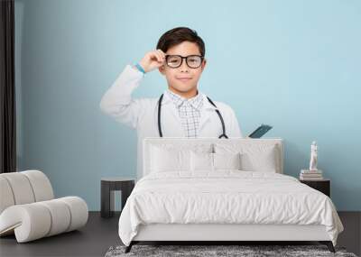 Smiling smart doctor boy with white medical coat and stethoscope Wall mural