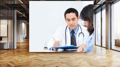 Woman patient consulting with Asian male doctor Wall mural