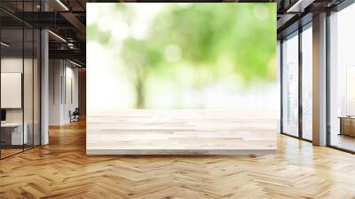 Wood table top on blur green background of trees in the park Wall mural