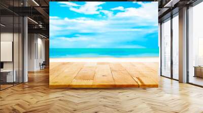 Wood table top on blur white sand beach and blue sky background Wall mural