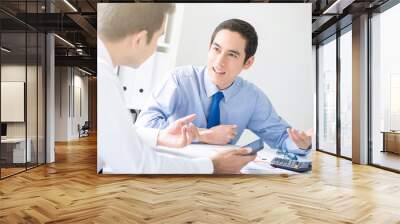 Young Asian businessmen consulting at meeting table Wall mural