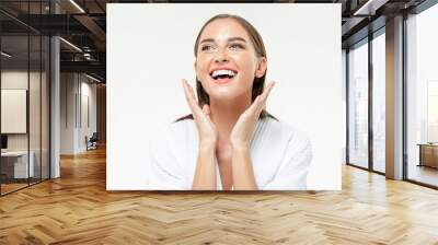 Young beautiful Caucasian woman with clear fresh skin smiling on white isolated studio background Wall mural