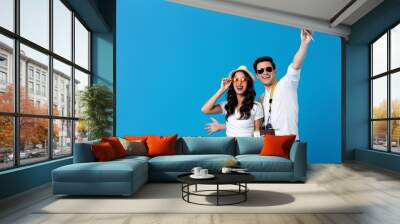 Young couple holding passports and ready for travel Wall mural