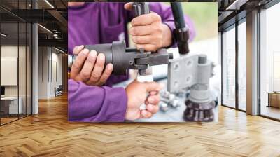 Two electrician builder workers installing high-voltage cable.Hydraulic tongs crimping that is used by workers to crimp ground wires in construction site at oil and gas plant or chemical plant. Wall mural