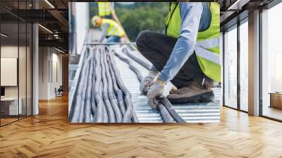 Workers are moving cables in construction sites. Wall mural