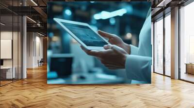 A business professional using a tablet in a contemporary office, illustrating the integration of technology in daily work. Wall mural