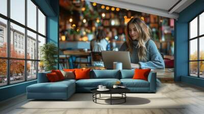 An entrepreneur working on a laptop in a co-working space, representing the modern startup culture Wall mural