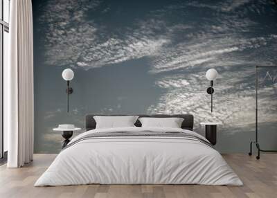 Clouds formation on a blue morning sky and beautiful evening sky. Wall mural