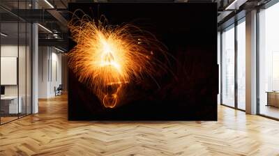 Abstract background of steel wool fireworks on Hat Chom Dao at after twilight blue hour, Showers of glowing sparks from spinning steel wool, Na Tan, Na Tan District, Ubon Ratchathani, Thailand Wall mural