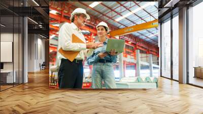 Factory workers or engineer worker working for check and analyze newly arrived goods using laptop and digital tablet, teamwork and synergy concept Wall mural