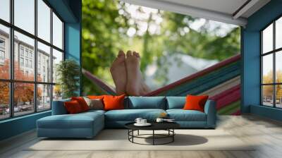 Closeup of feet of a child lying in a hammock Wall mural