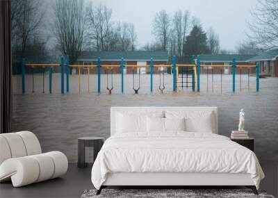 A playground submerged in floodwaters, showcasing the impact of severe weather conditions on community spaces. Wall mural