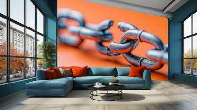 broken metal chain link on orange background - symbol of weakness, vulnerability, and disconnection Wall mural