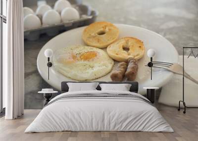 Egg sausage and bagel toast with ground black pepper on a breakfast plate. Wall mural