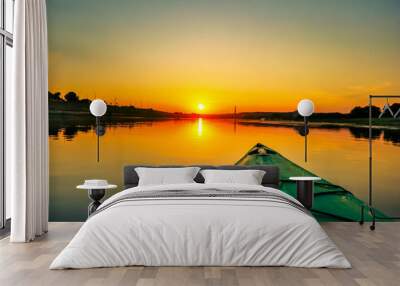 View of front of kayak, floating on the river at summer sunset Wall mural