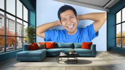 Smiling facial expression young asian man happy looking at camera, isolated on white background Wall mural