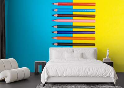 Back to scool - Pencils detail. Colored sharp pencils detail in a row, isolated on blue and yellow. Wall mural