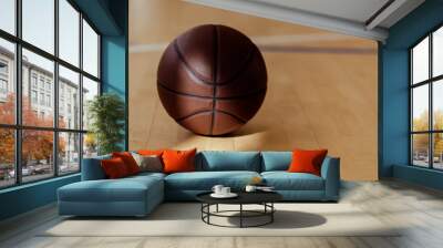 Basketball on hardwood court floor with natural lighting. Workout online concept. Horizontal sport poster, greeting cards, headers, website... Wall mural