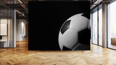 Closeup of football ball on black background Wall mural