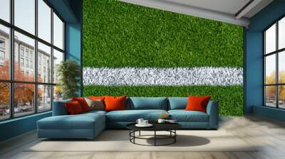 Green synthetic grass sports field with white line shot from above. Sports background for product display, banner, or mockup. Wall mural