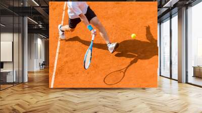 Old male tennis player in action on the court on a sunny day Wall mural