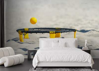 Spike ball game with yellow ball on sand. Summer game concept Wall mural