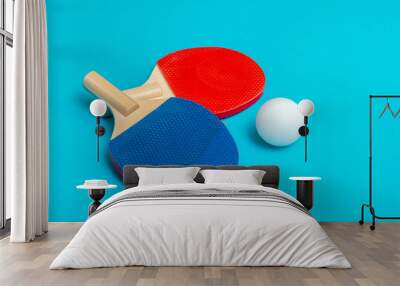 Two rackets for playing table tennis on blue background Wall mural