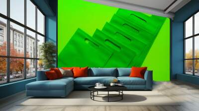 bunch of green tote bags on an elegant light green background. spunbond bags are made of polypropylene. Wall mural