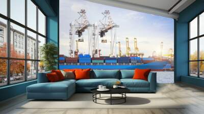 Container Cargo freight ship with working crane bridge in shipyard at dusk for Logistic Import Export background Wall mural