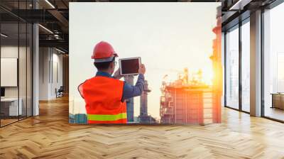 Engineer working with tablet PC near power plant Wall mural