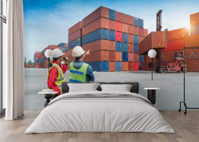 Foreman control loading Containers box from Cargo freight ship in Warehouse Wall mural